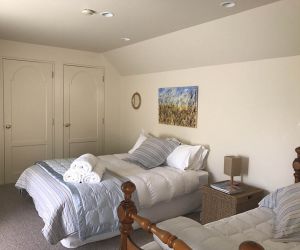 Upstairs bedroom with a queen size bed and a single
